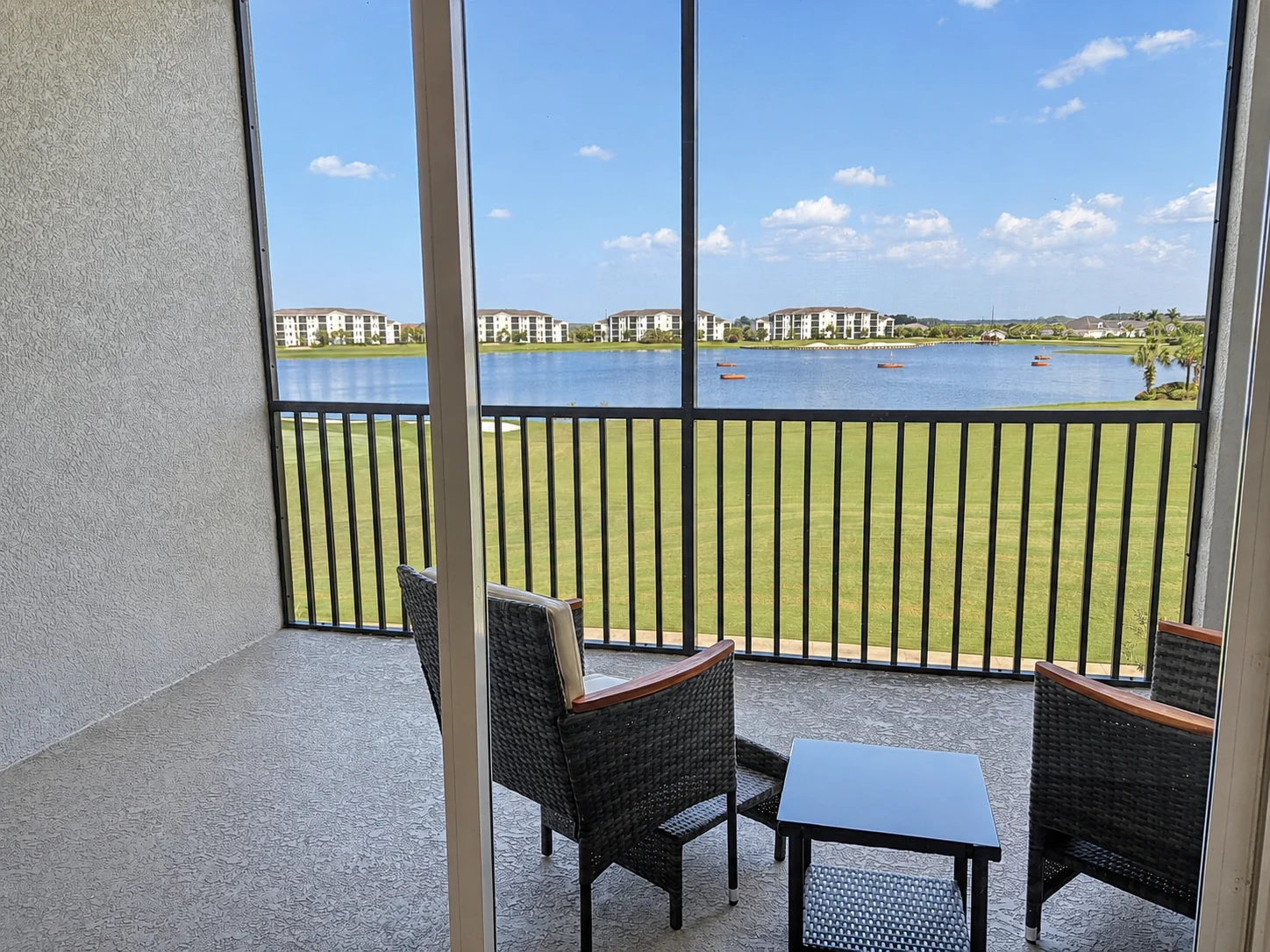 Screened terrace with expansive lake view at the Ave Maria Residence